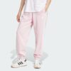 JE1272_000_plp_model.jpgJE1272_000_plp_model.jpg Pantalones holgados de vellón de 3 bandas Adidas Essentials para mujer-