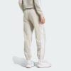 JX7697_23_hover_model.jpg Pantalones holgados de vellón de 3 bandas Adidas Essentials para mujer-